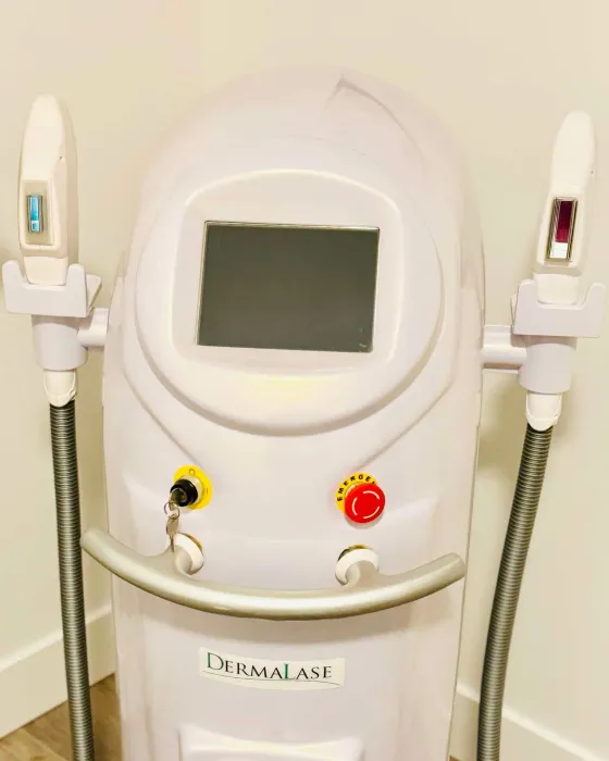 The DermaLase laser system in the treatment room, with its two handpieces resting either side